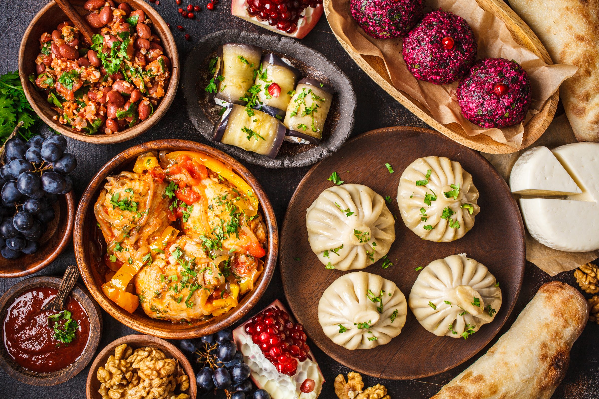 A table of Georgian dishes with khinkali, khachapuri and pkhali