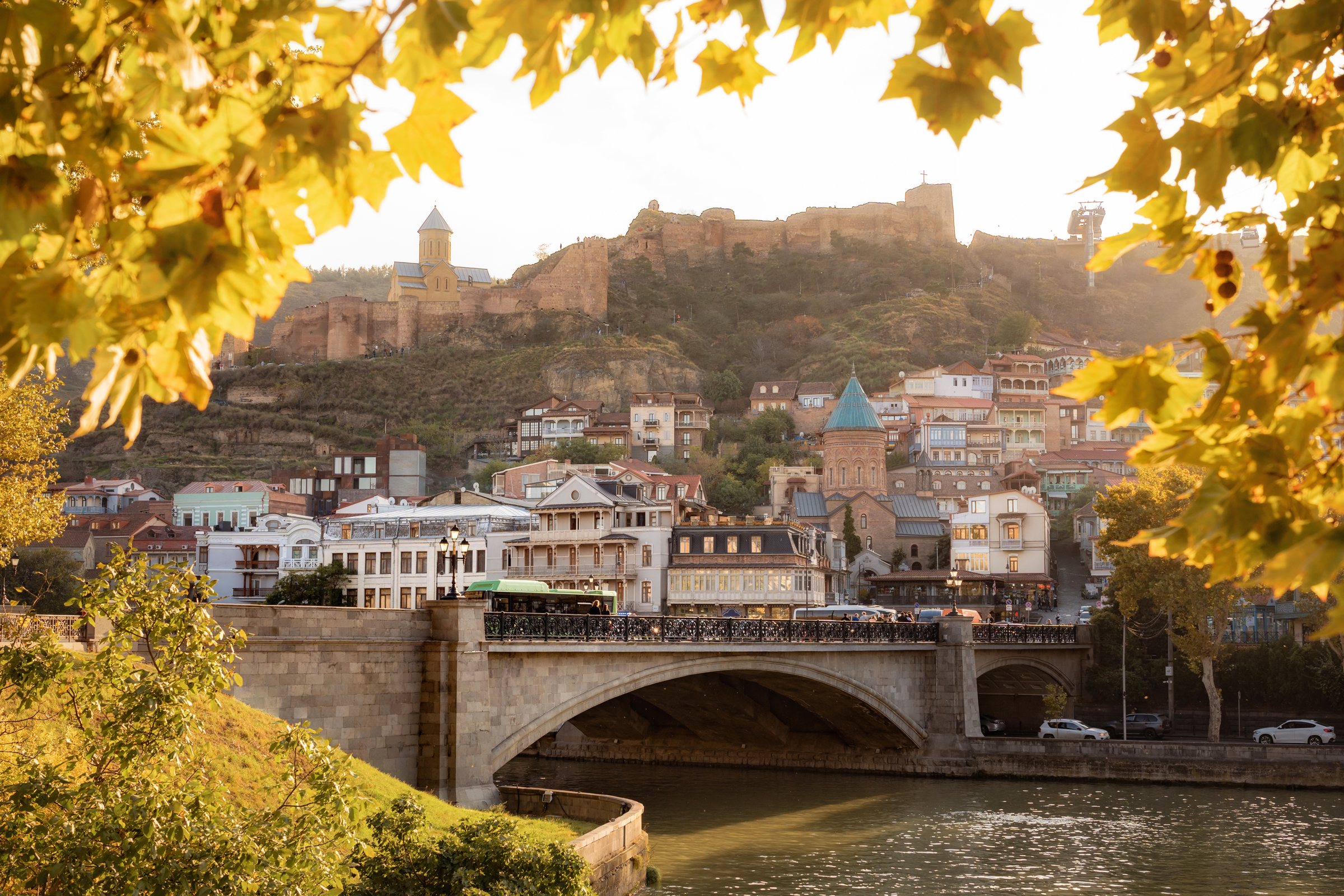 Old Tbilisi and Narikala Fortress framed by autumn leaves